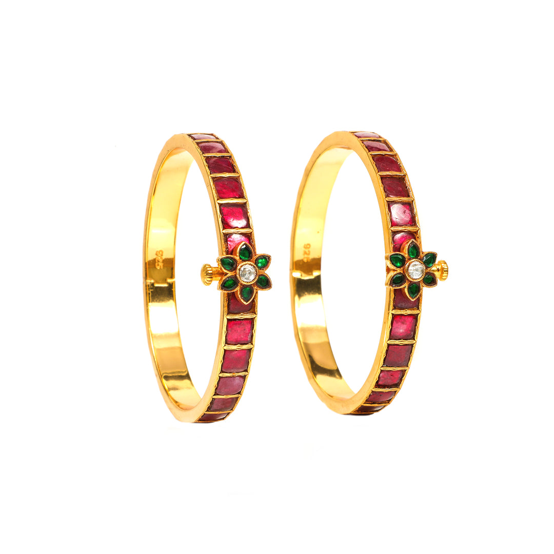 Rangrez Slim: slim red-stone bangles with a green floral accent and clear centre stone