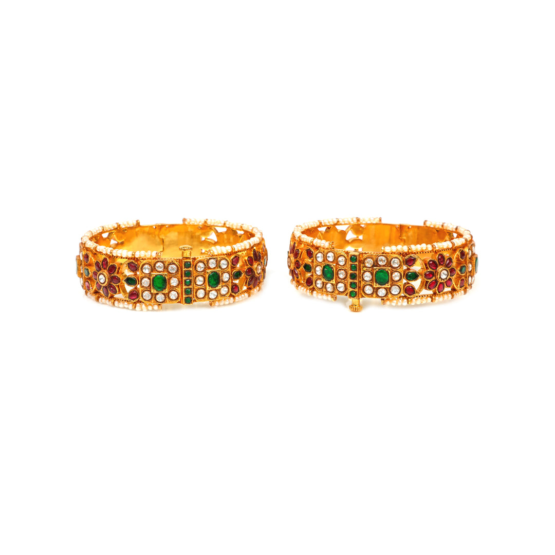 Rajputana Heritage: broad bangles with red and green accents, clear stone clusters, floral motifs and pearl-style edging
