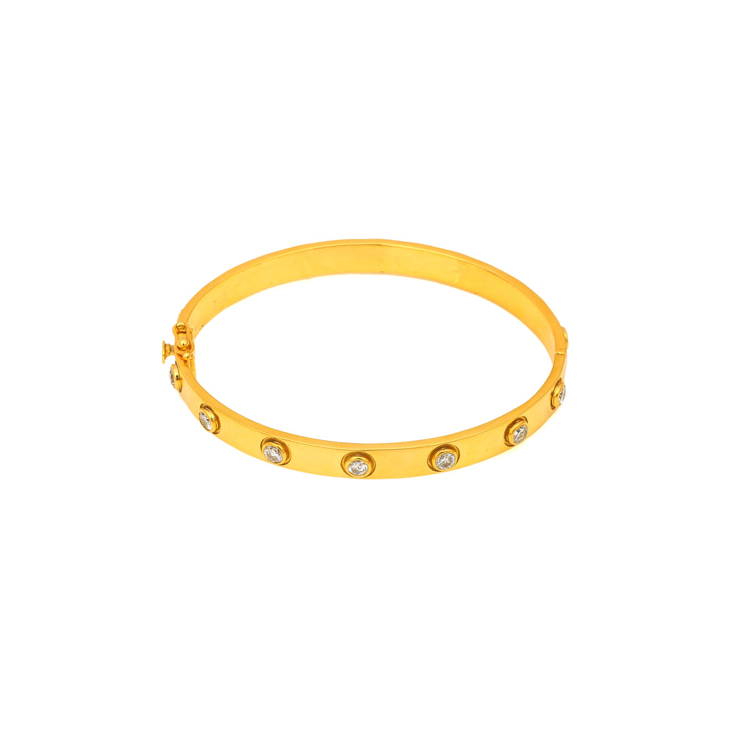 Classic Gold-Tone: slim gold-tone bangle with a clean polished profile and small decorative accents