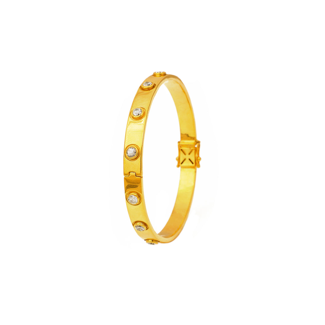 Classic Gold-Tone: slim gold-tone bangle with a clean polished profile and small decorative accents