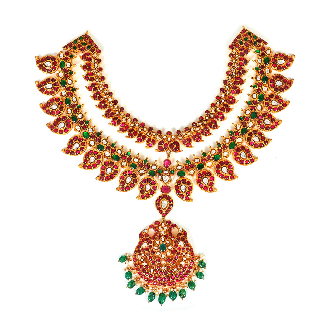Padma Ruby Collar: curved collar necklace with red and green accents and a central circular pendant