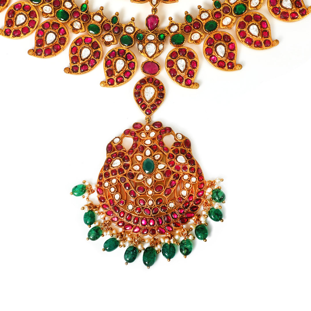 Padma Ruby Collar: curved collar necklace with red and green accents and a central circular pendant