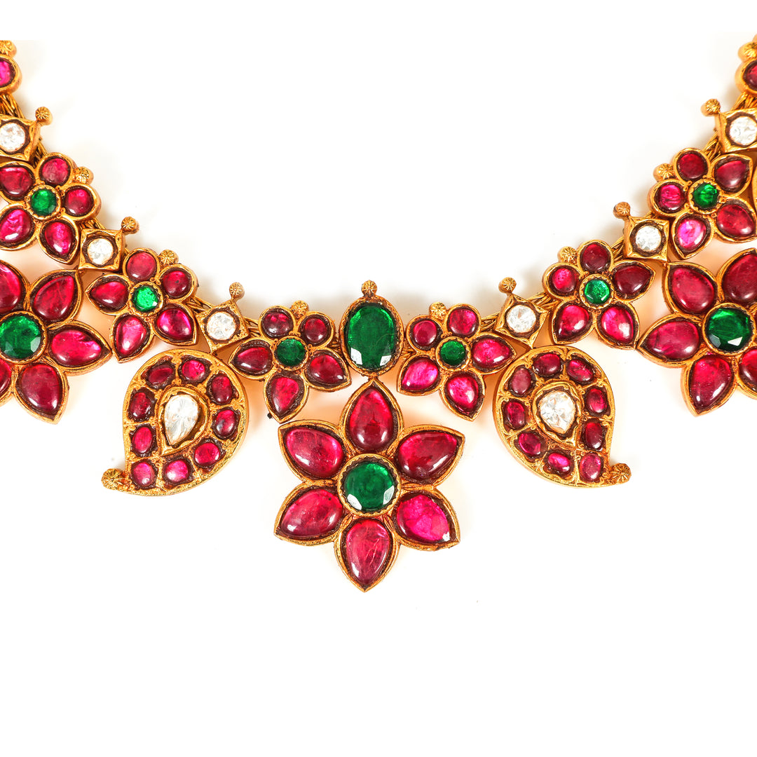 Gulabi Floral Collar: curved necklace with repeating red floral motifs and green accents