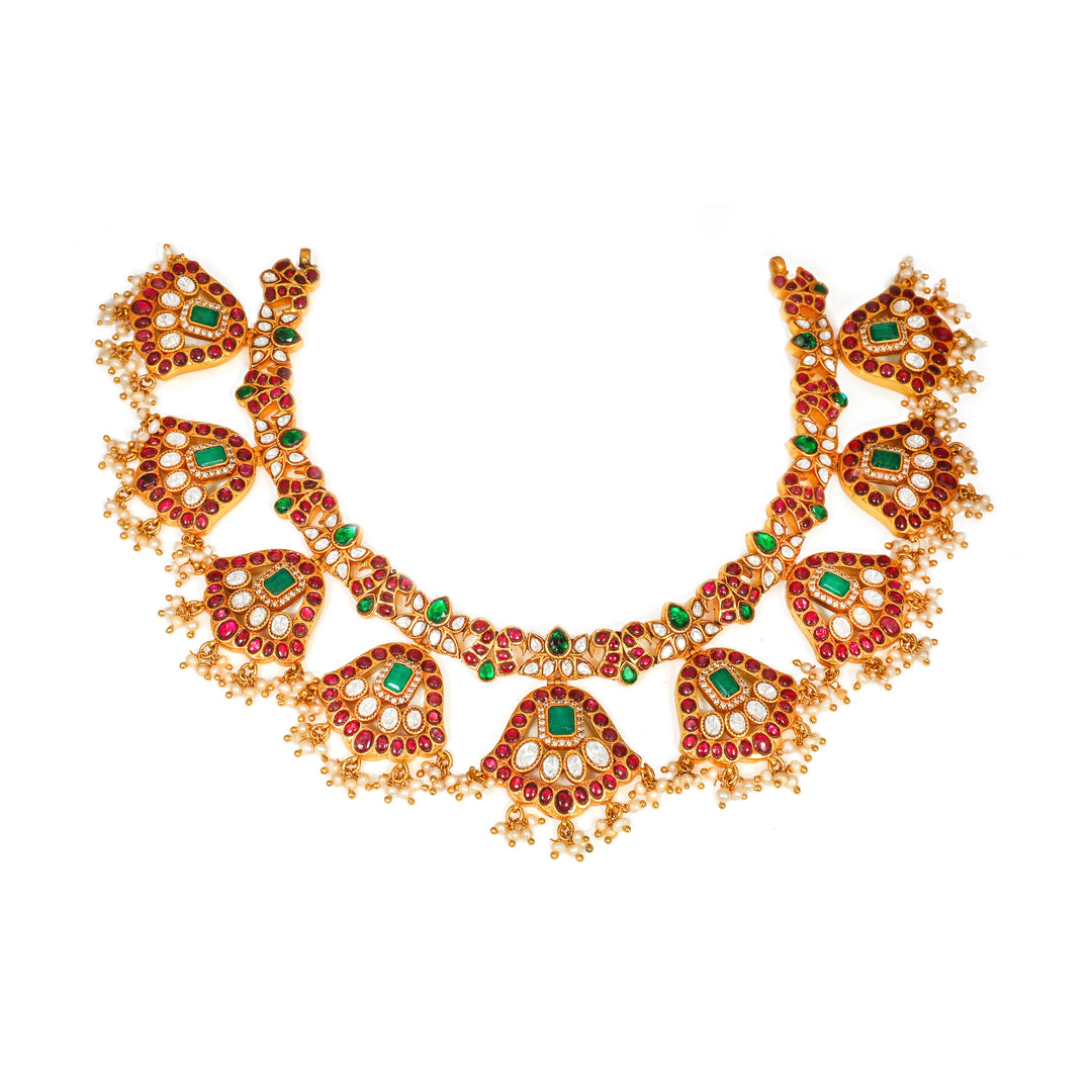 Meenakari Floral Collar: curved necklace with repeating floral medallions and green and red accents