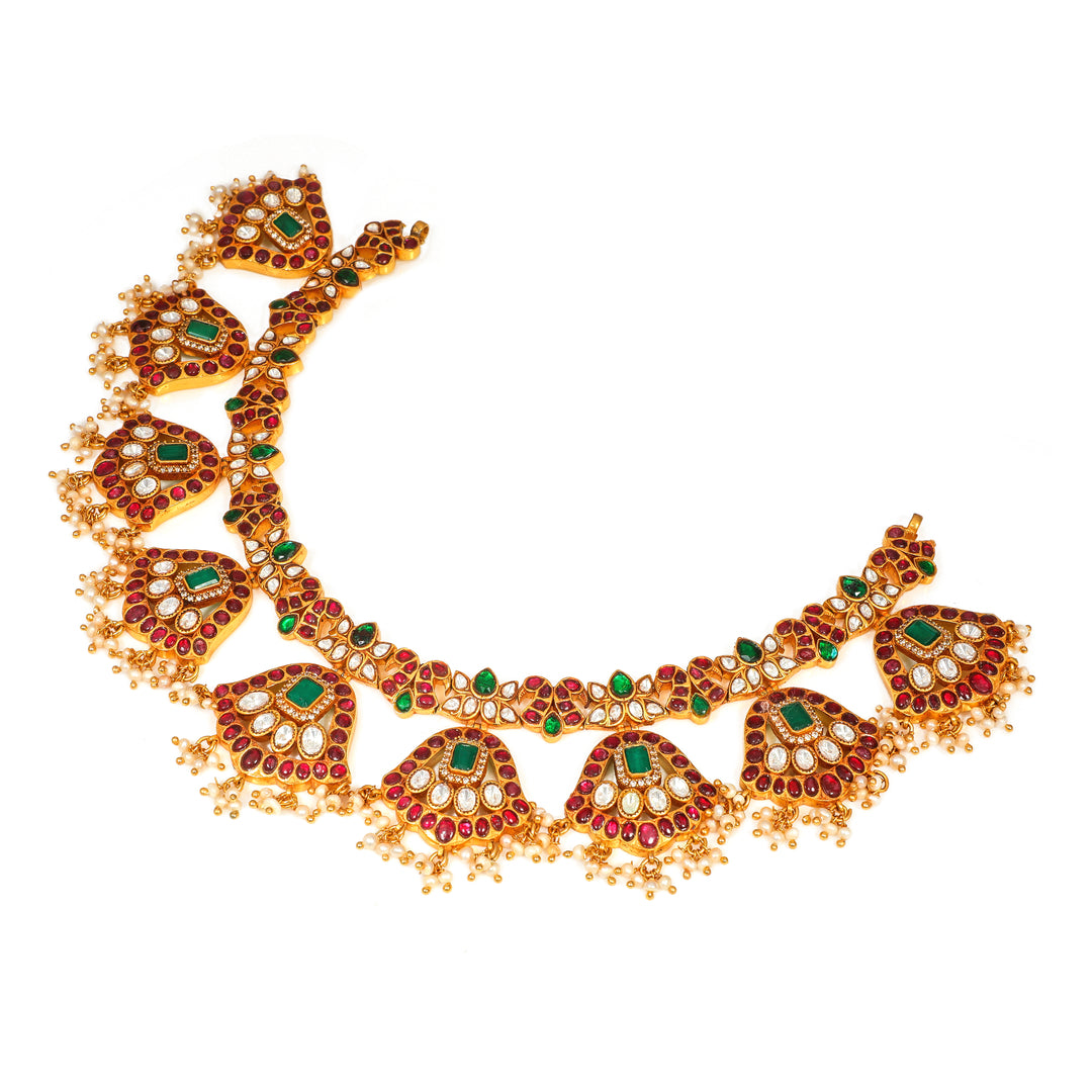 Meenakari Floral Collar: curved necklace with repeating floral medallions and green and red accents