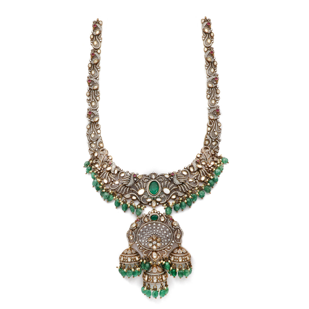 Emerald Jhumka Necklace: ornate necklace with green centre accents and a large traditional hanging pendant