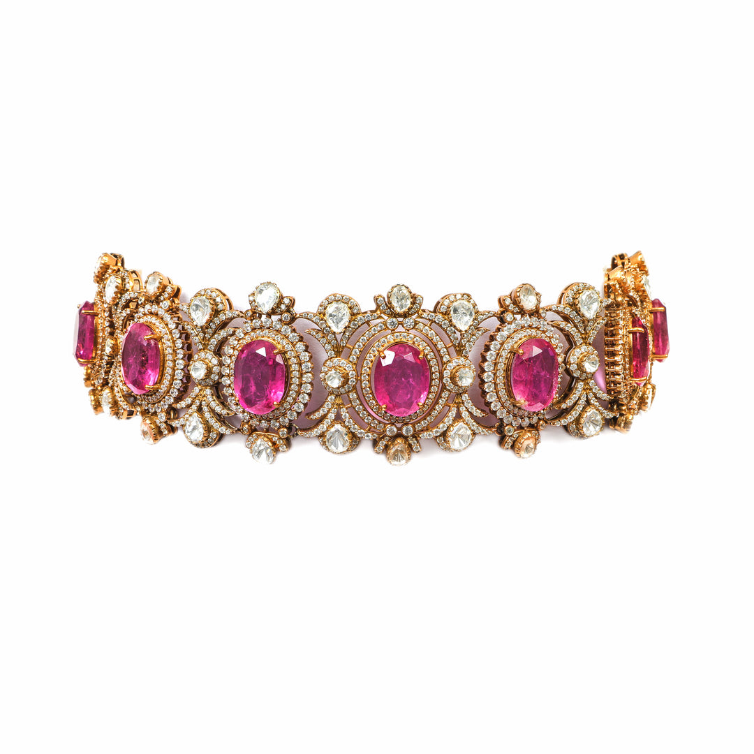 Rani Pink Stone Bracelet: wide bracelet with repeating pink oval stones and ornate gold-tone detailing