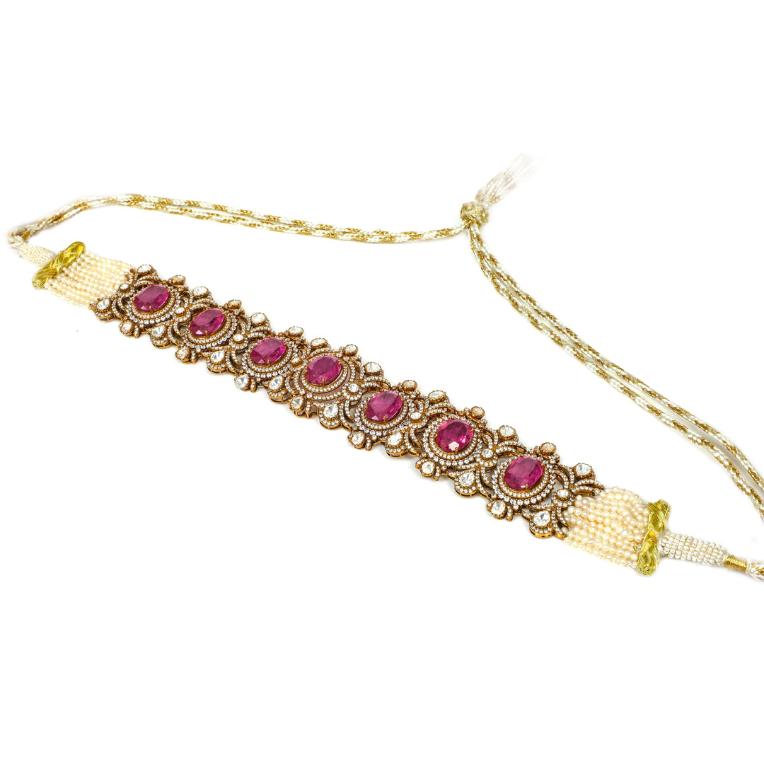 Rani Pink Stone Bracelet: wide bracelet with repeating pink oval stones and ornate gold-tone detailing